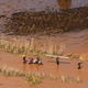 People wade through flood waters in the rural neighborhood of Buzi in Mozambique on March 24, 2019.